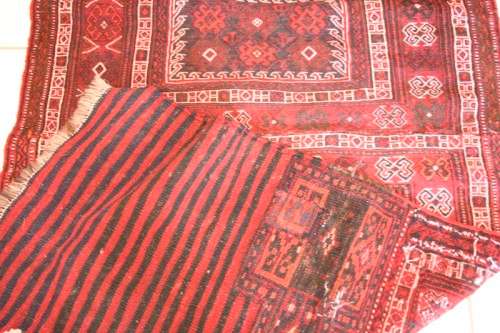 A spectacular (1.10m x 2.54m) Turkish Kilim carpet with reds, pinks, black & white colours