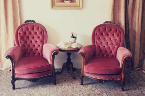 Two elegant hand carved Victorian arm chairs with deep button detailing & gorgeous pink fabric.