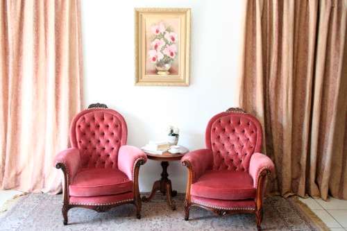 Two elegant hand carved Victorian arm chairs with deep button detailing & gorgeous pink fabric.