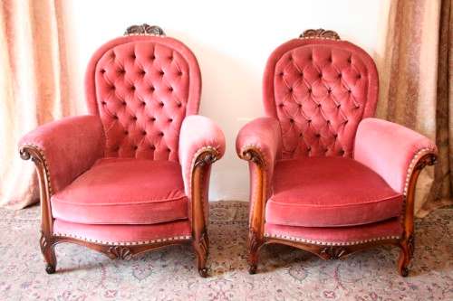 Two elegant hand carved Victorian arm chairs with deep button detailing & gorgeous pink fabric.