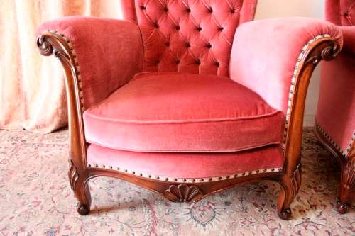 Two elegant hand carved Victorian arm chairs with deep button detailing & gorgeous pink fabric.