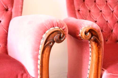 Two elegant hand carved Victorian arm chairs with deep button detailing & gorgeous pink fabric.
