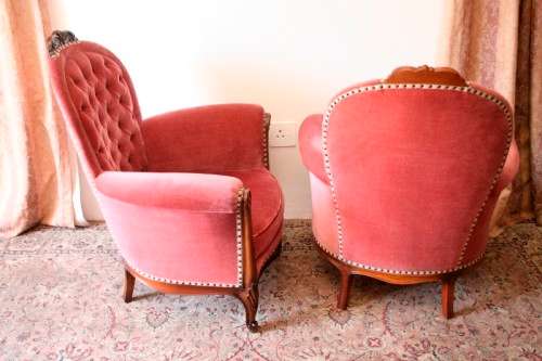 Two elegant hand carved Victorian arm chairs with deep button detailing & gorgeous pink fabric.