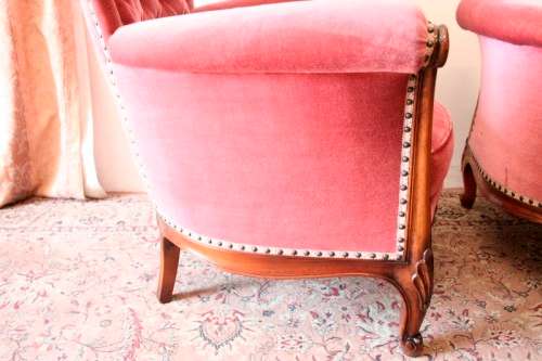 Two elegant hand carved Victorian arm chairs with deep button detailing & gorgeous pink fabric.