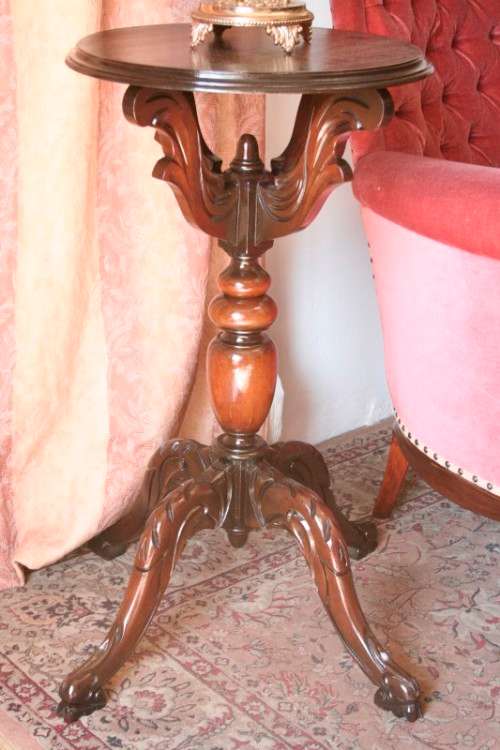 An exquisite hand-carved round Imbuia occasional/ side table with a solid turned centre base.
