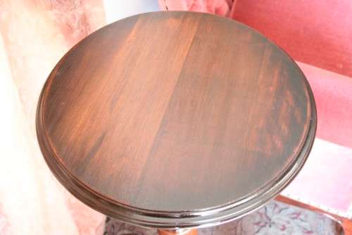 An exquisite hand-carved round Imbuia occasional/ side table with a solid turned centre base.