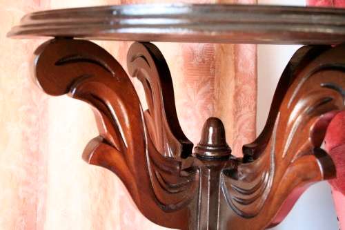 An exquisite hand-carved round Imbuia occasional/ side table with a solid turned centre base.