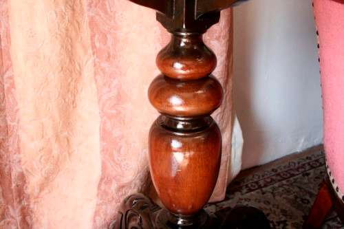 An exquisite hand-carved round Imbuia occasional/ side table with a solid turned centre base.