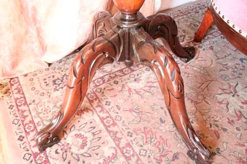 An exquisite hand-carved round Imbuia occasional/ side table with a solid turned centre base.