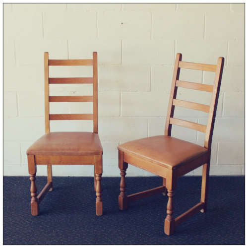Two stunning vintage solid Oak ladder back dining chairs with genuine leather upholstered seats