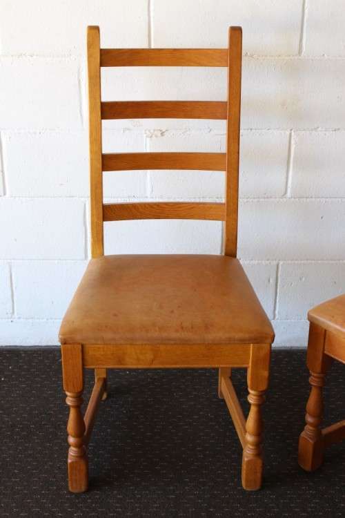 Two stunning vintage solid Oak ladder back dining chairs with genuine leather upholstered seats
