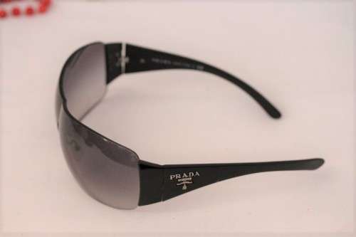 An awesome pair of black Italian made Prada (model SPR22M) ladies sunglasses w/ grey gradient lenses