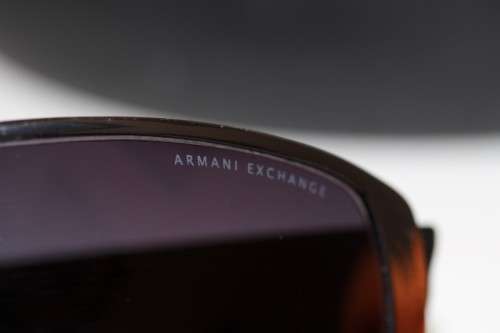 An incredible pair of black Armani Exchange (model AX008NS) unisex sunglasses in its original box