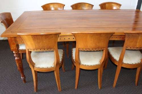 A magnificent Balinese Teak 8-seater dining suite with stylish upholstered curved-back chairs