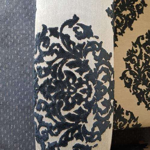 A one seater sofa chair upholstered in a stunning brocade fabric with wooden legs