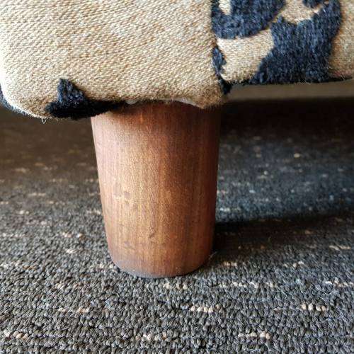 A one seater sofa chair upholstered in a stunning brocade fabric with wooden legs