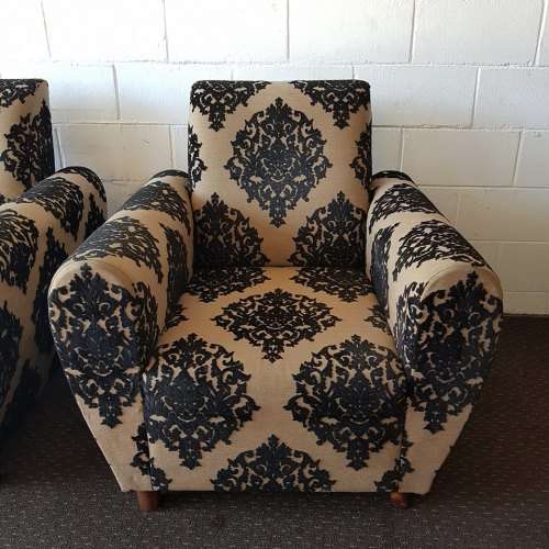 A one seater sofa chair upholstered in a stunning brocade fabric with wooden legs