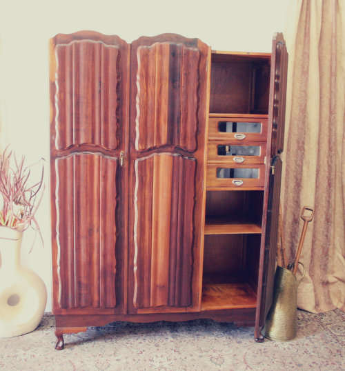 A stunning vintage Imbuia ball and claw three door wardrobe with three glass window drawers.