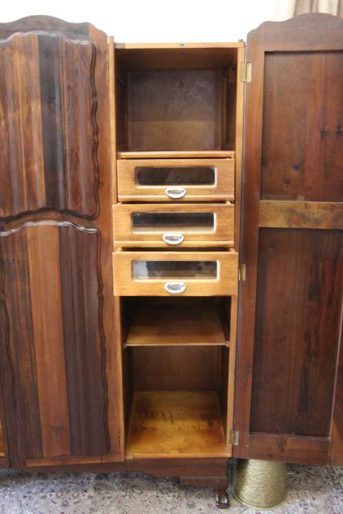 A stunning vintage Imbuia ball and claw three door wardrobe with three glass window drawers.