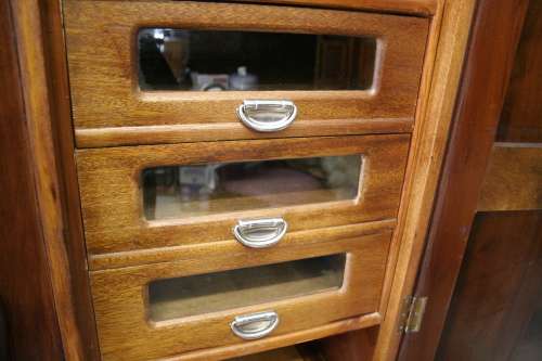 A stunning vintage Imbuia ball and claw three door wardrobe with three glass window drawers.