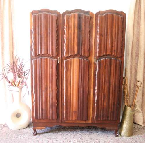 A stunning vintage Imbuia ball and claw three door wardrobe with three glass window drawers.