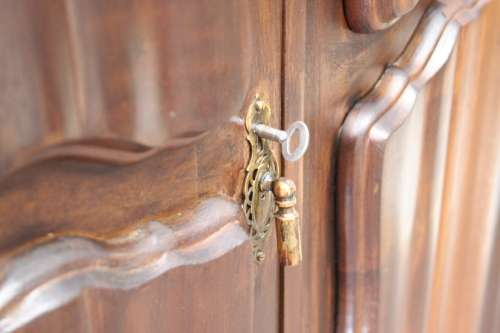 A stunning vintage Imbuia ball and claw three door wardrobe with three glass window drawers.