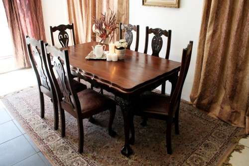 A stunning vintage Ball & Claw dining room suite with 6 fabulous carved chairs