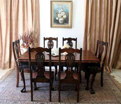 A stunning vintage Ball & Claw dining room suite with 6 fabulous carved chairs