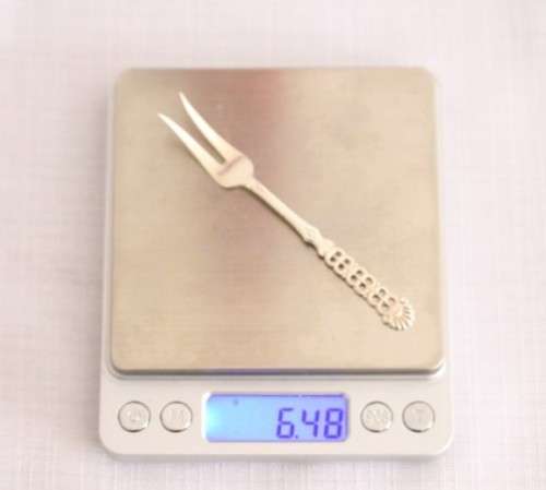 A wonderful antique European Art Deco 830S solid silver 2-prong shellfish fork with ornate detailing