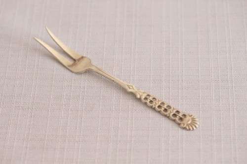 A wonderful antique European Art Deco 830S solid silver 2-prong shellfish fork with ornate detailing
