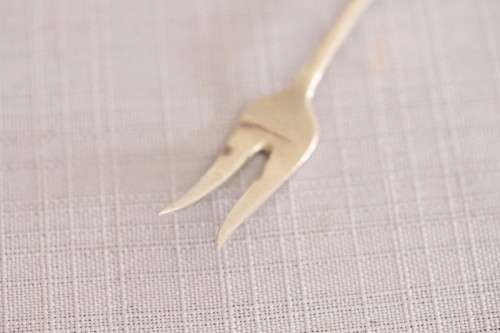 A wonderful antique European Art Deco 830S solid silver 2-prong shellfish fork with ornate detailing