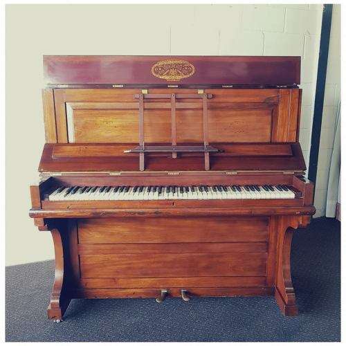 A spectacular antique Edwardian "John Brinsmead & Sons" upright piano - elegant addition to a lounge