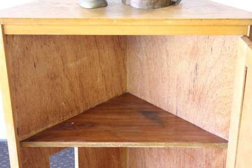 A lovely Oak single-door corner cabinet with shelves on the inside. Perfect for smaller spaces!!