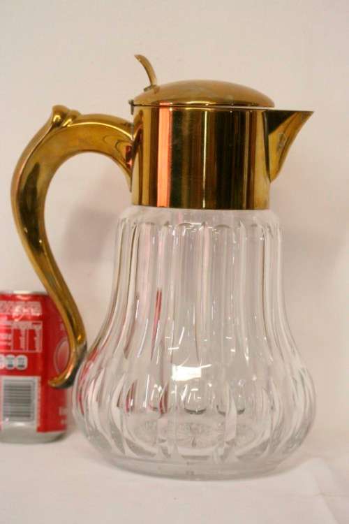 A spectacular lead crystal water jug with a cooler for ice, brass lid and handle in good condition