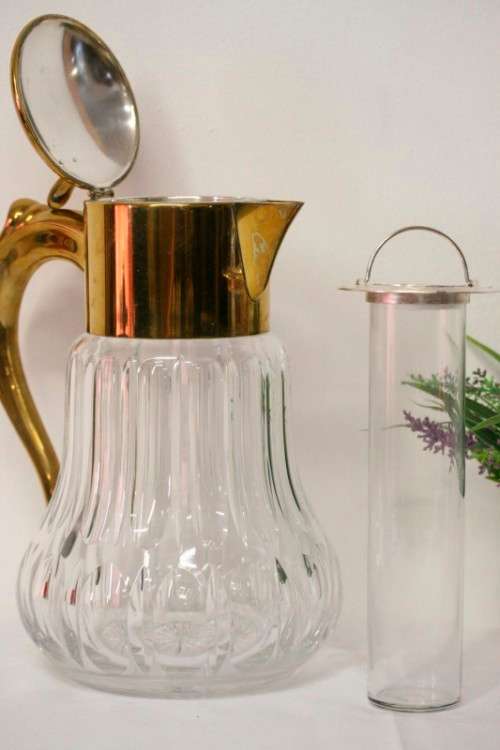 A spectacular lead crystal water jug with a cooler for ice, brass lid and handle in good condition