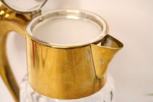 A spectacular lead crystal water jug with a cooler for ice, brass lid and handle in good condition