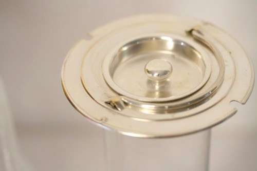 A spectacular lead crystal water jug with a cooler for ice, brass lid and handle in good condition