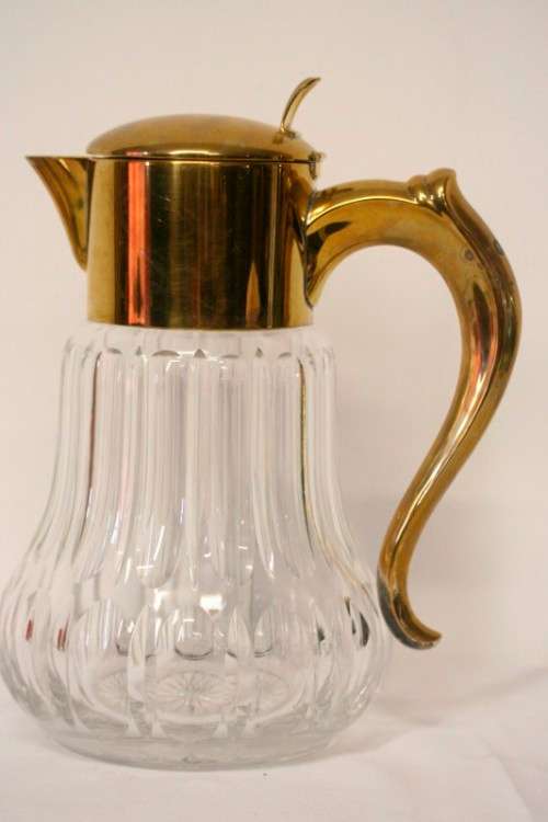 A spectacular lead crystal water jug with a cooler for ice, brass lid and handle in good condition