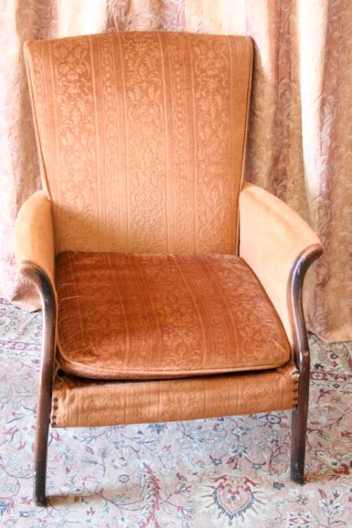 A gorgeous vintage upholstered arm chair, fantastic in a sun room, patio or on a porch!