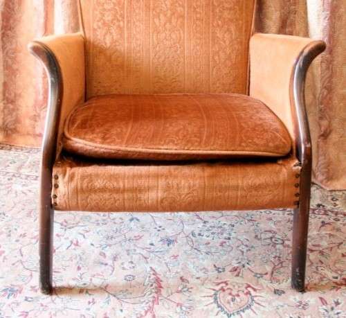 A gorgeous vintage upholstered arm chair, fantastic in a sun room, patio or on a porch!
