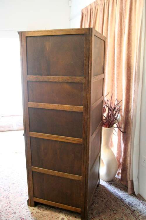 An exquisite vintage solid oak corner display cabinet with lead glass doors and a large cupboard.