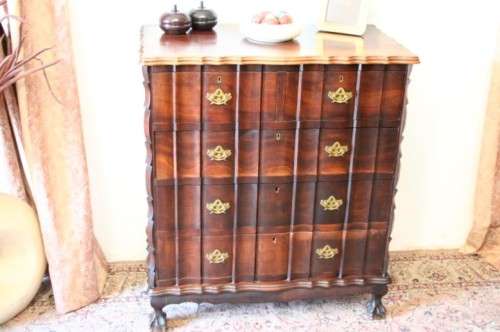 An exquisite vintage Imbuia 5-drawer chest of drawers with ornate handles and ample storage space