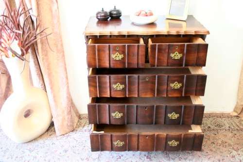 An exquisite vintage Imbuia 5-drawer chest of drawers with ornate handles and ample storage space