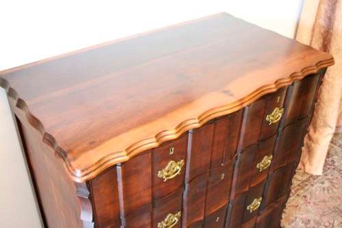An exquisite vintage Imbuia 5-drawer chest of drawers with ornate handles and ample storage space