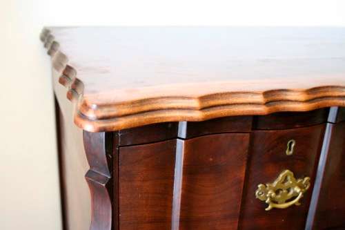 An exquisite vintage Imbuia 5-drawer chest of drawers with ornate handles and ample storage space