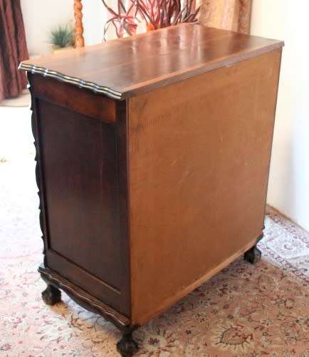 An exquisite vintage Imbuia 5-drawer chest of drawers with ornate handles and ample storage space