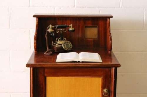 **RS17_Clearance** Yellow wood & mahogany panelled concierge pedestal w/ a large cupboard