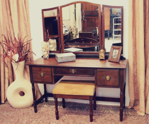 An exquisite three-drawer Imbuia dressing table with side-folding mirrors and a stool