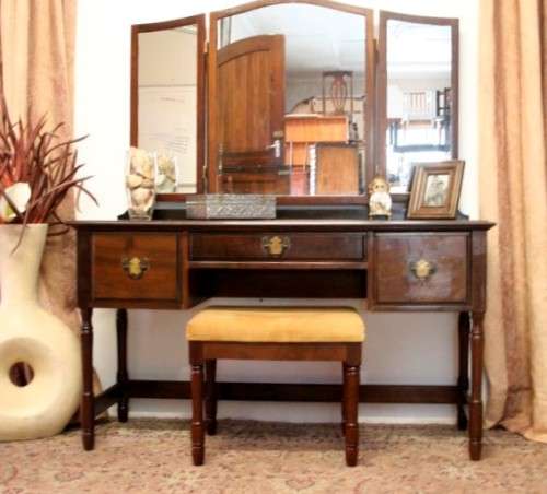 An exquisite three-drawer Imbuia dressing table with side-folding mirrors and a stool