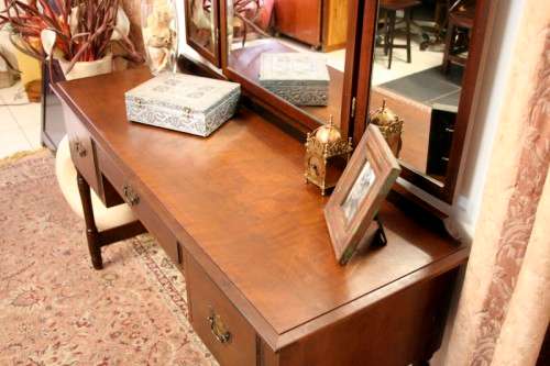 An exquisite three-drawer Imbuia dressing table with side-folding mirrors and a stool
